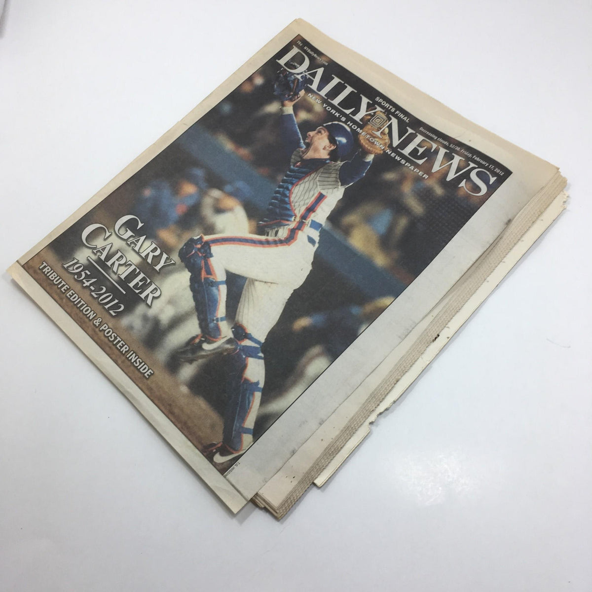 Tribute edition cover of the New York Daily News from February 17, 2012, honoring Gary Carter (1954-2012). The image depicts Carter in an iconic pose, celebrating his contributions to baseball.