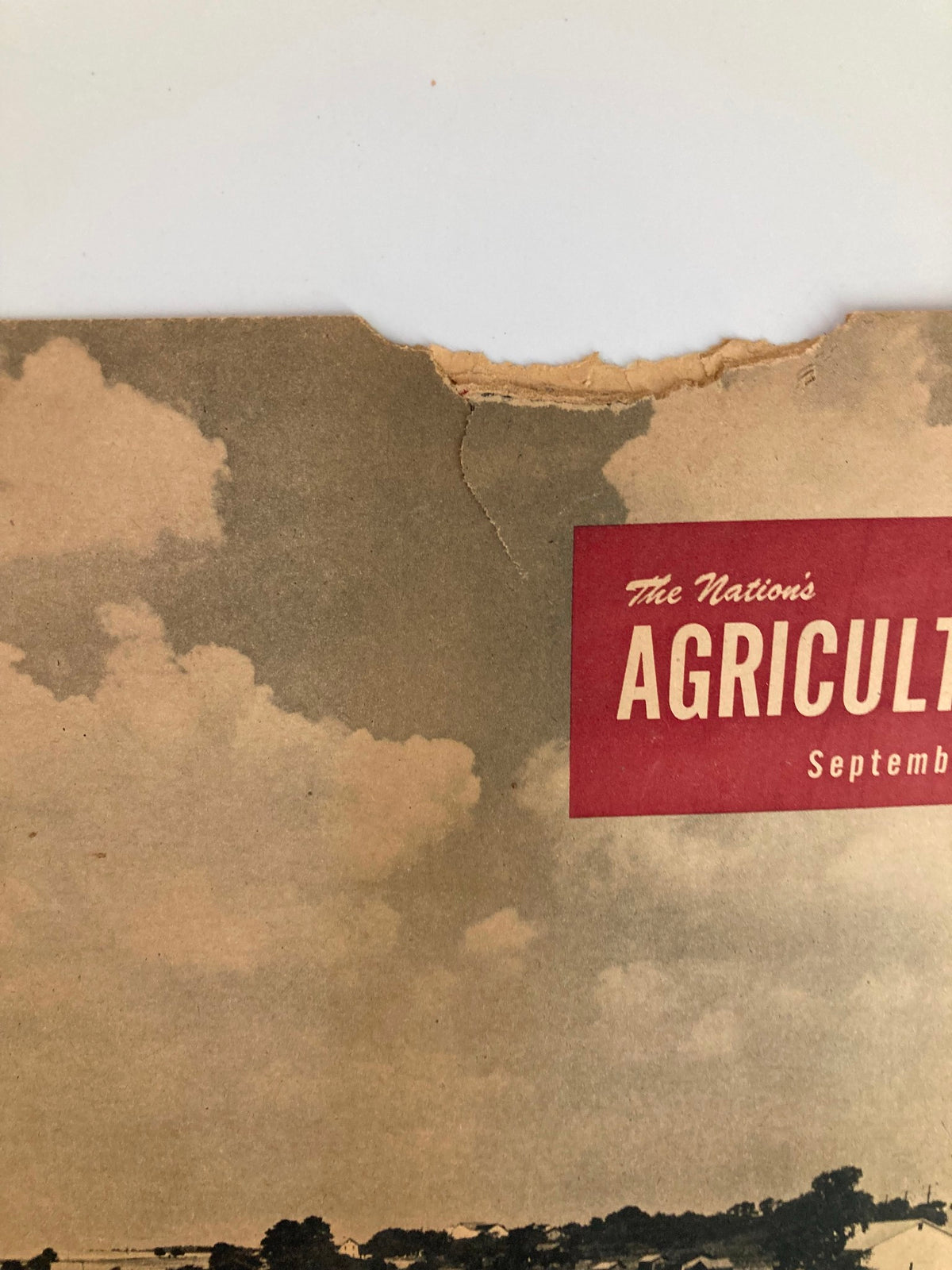 Close-up view of the top section of VTG The Nation's Agriculture Magazine - September 1950, showing the title and clouds above the harvest scene.