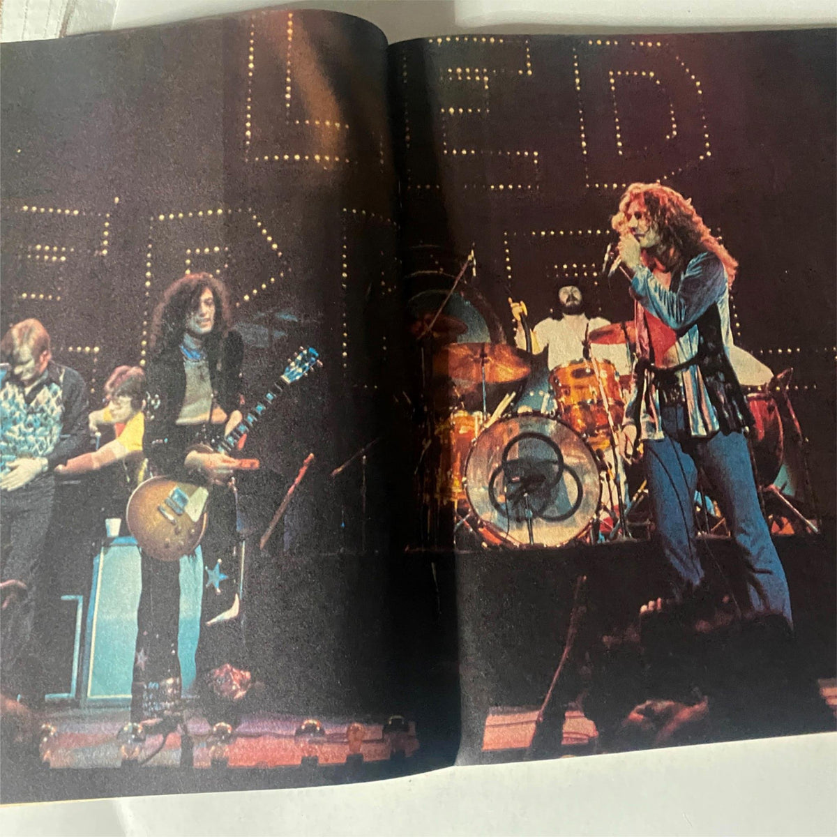 Concert image of Led Zeppelin performing, featured in the VTG Hit Parader Yearbook Summer Fall 1975.