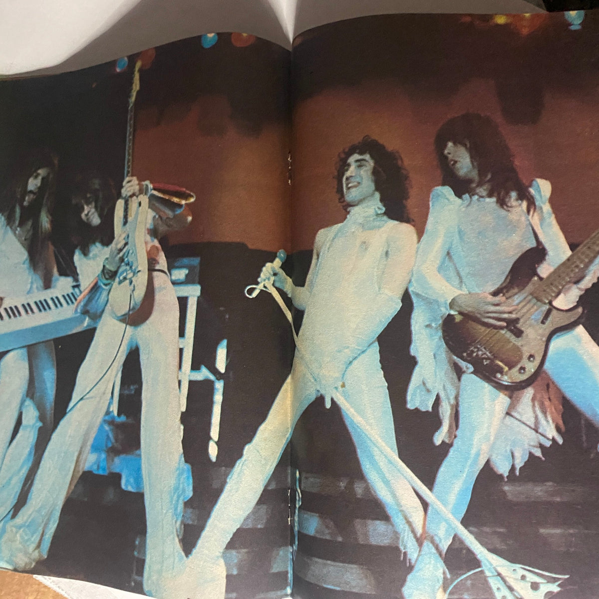 Inside spread of the VTG Hit Parader Magazine August 1977 showcasing a performance by classic rock band Boston with band members in iconic white outfits.