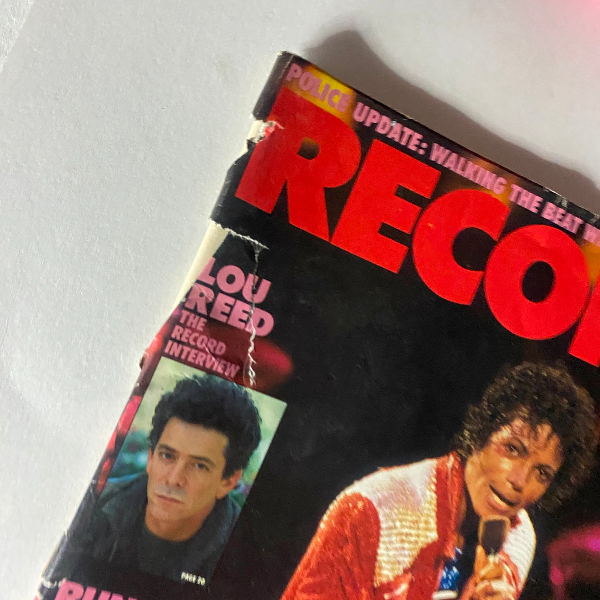 Close-up of the October 1984 Record Magazine cover, highlighting Michael Jackson and Lou Reed's interviews, encapsulating the music culture of the 1980s.