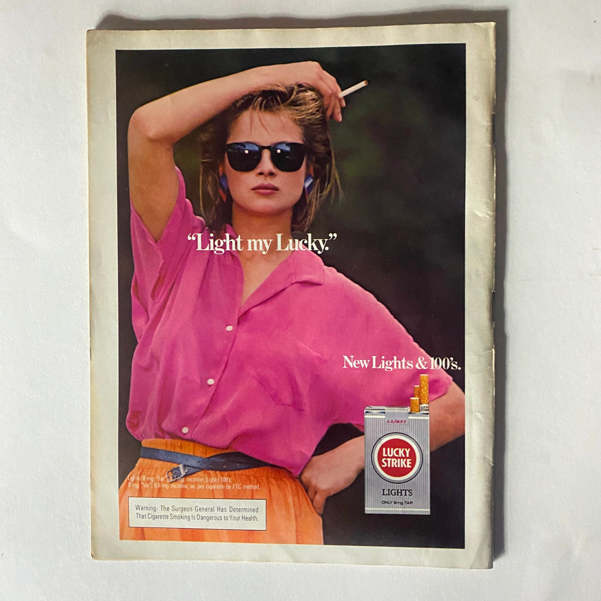 Advertisement from VTG Record Magazine May 1985 Vol 4 No. 7 featuring a model promoting Lucky Strike Lights cigarettes, representing 1980s advertising.