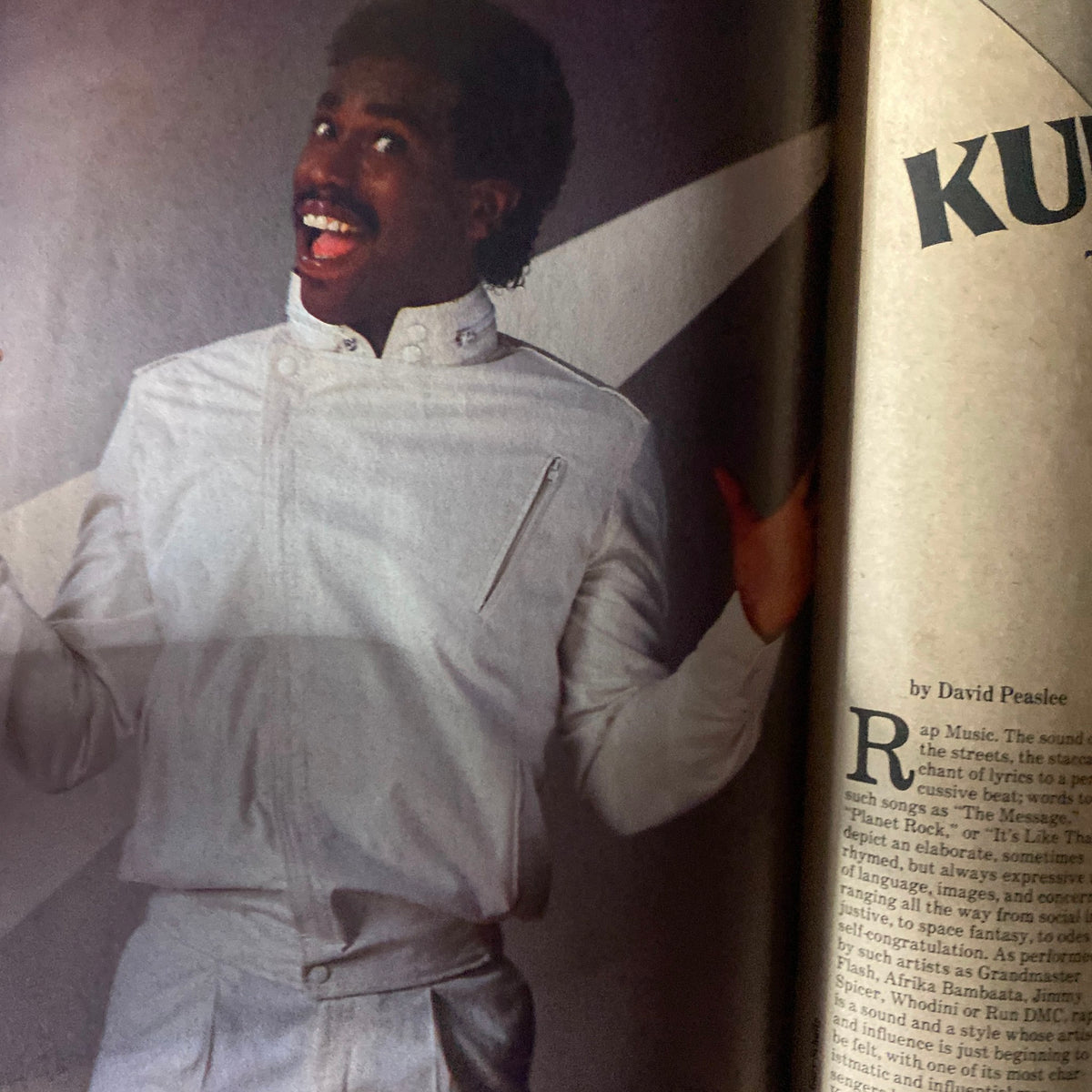 Image from VTG Black Beat Magazine December 1983 featuring Jeffrey Osborne in a stylish white outfit, showcasing the vibrant R&B scene of the 1980s.