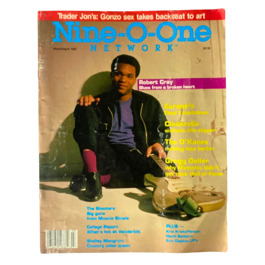 Cover of VTG Nine-O-One Network Magazine March 1987 featuring Robert Cray, showcasing the vibrant music scene of the 1980s. The magazine includes articles on music and culture, with a striking photograph of Cray.
