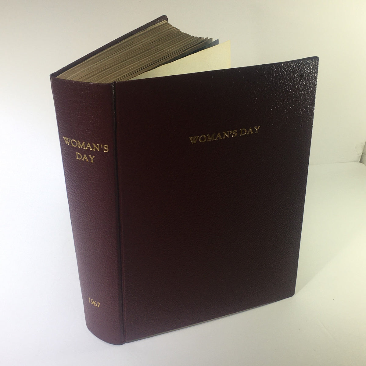 1967 Woman's Day Magazine Compilation showcasing the book's leather binding and gold embossing.
