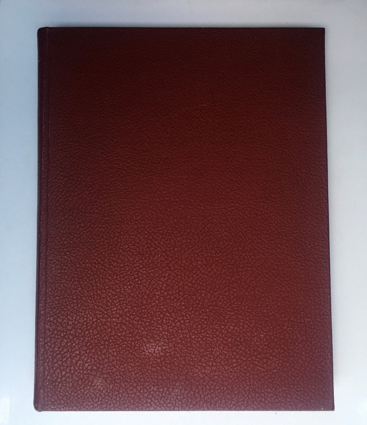 1937-1938 Woman's Day Magazine Compilation showing the plain cover of the book with a textured burgundy finish.