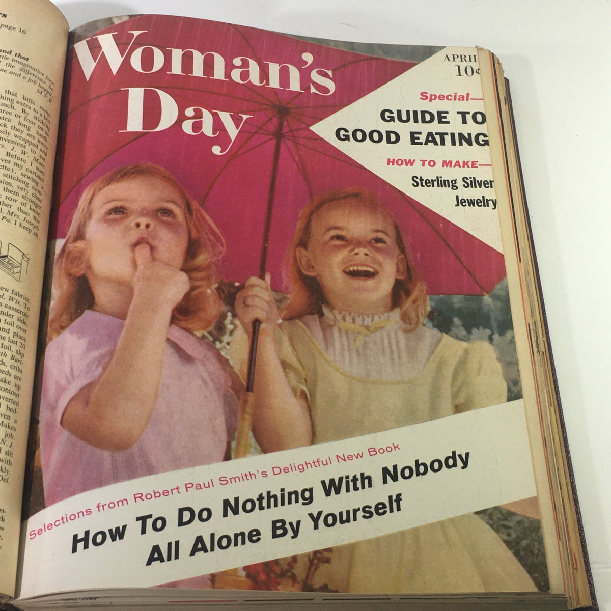 Cover image of the 1958 Woman's Day Magazine featuring two girls with an umbrella and the title 'Guide to Good Eating'.
