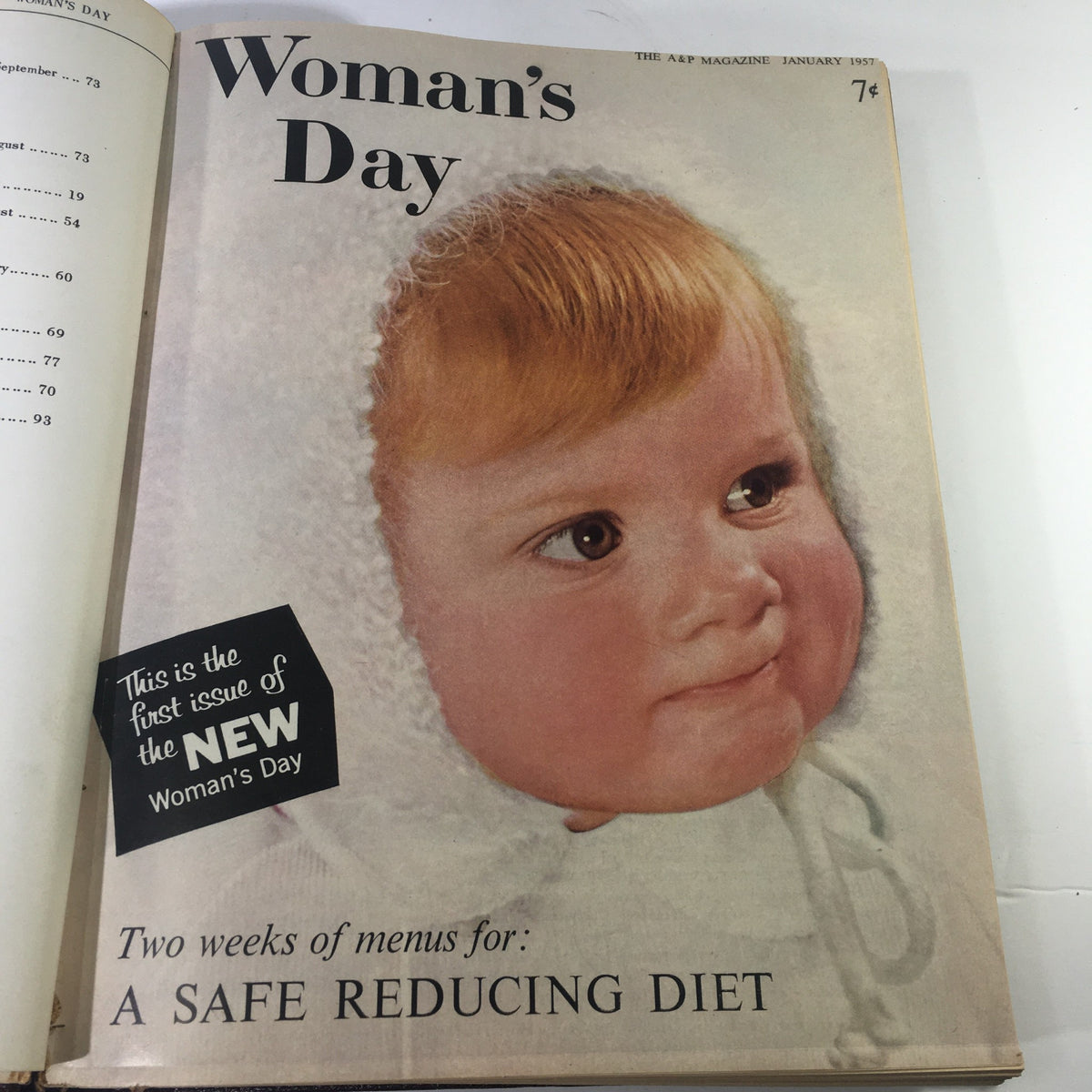 Cover of 1957 Woman's Day Magazine featuring a baby with orange hair, showcasing the first issue of the magazine and a safe reducing diet.