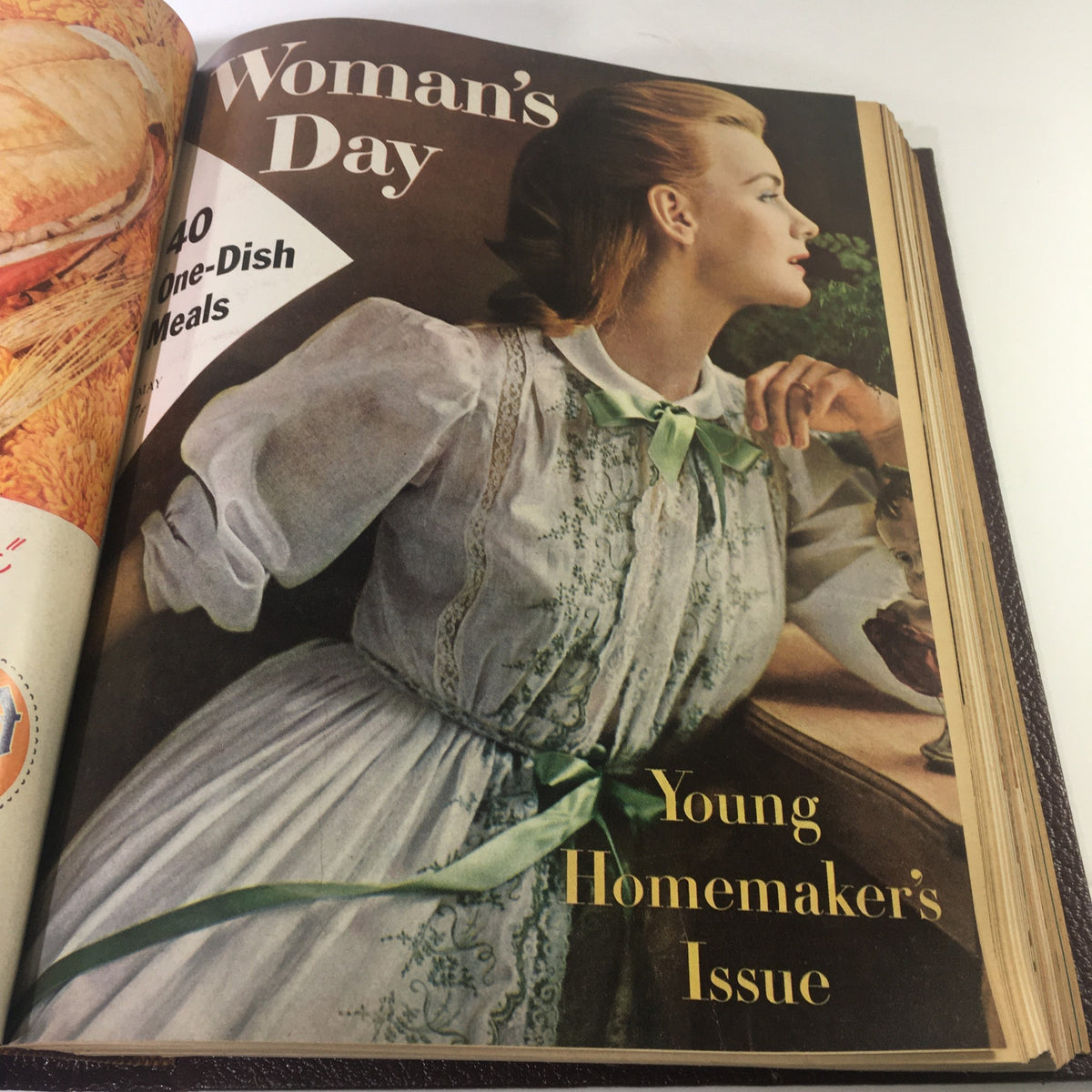 Cover of 1957 Woman's Day Magazine with a young woman in a vintage dress, focusing on one-dish meals for homemakers.