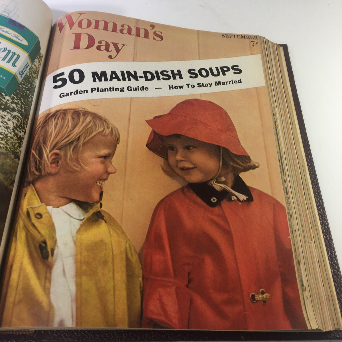 Cover of September 1957 Woman's Day Magazine showcasing two children in rain gear, emphasizing seasonal recipes and family activities.