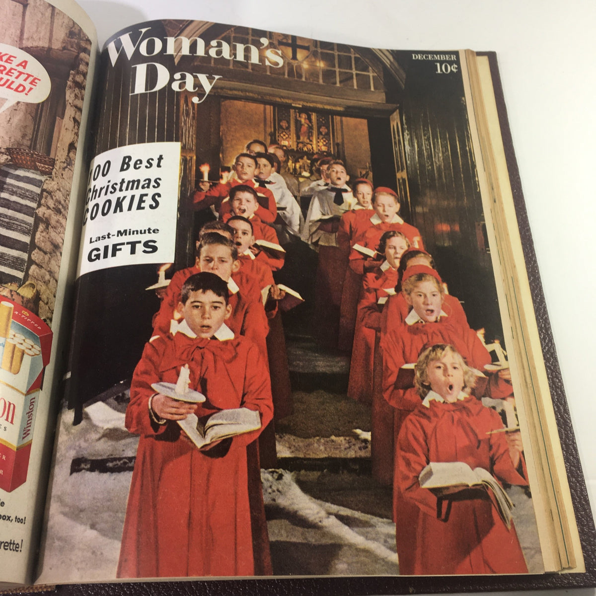 Cover of December 1957 Woman's Day Magazine displaying a children's choir in red robes, featuring holiday recipes and gift ideas.