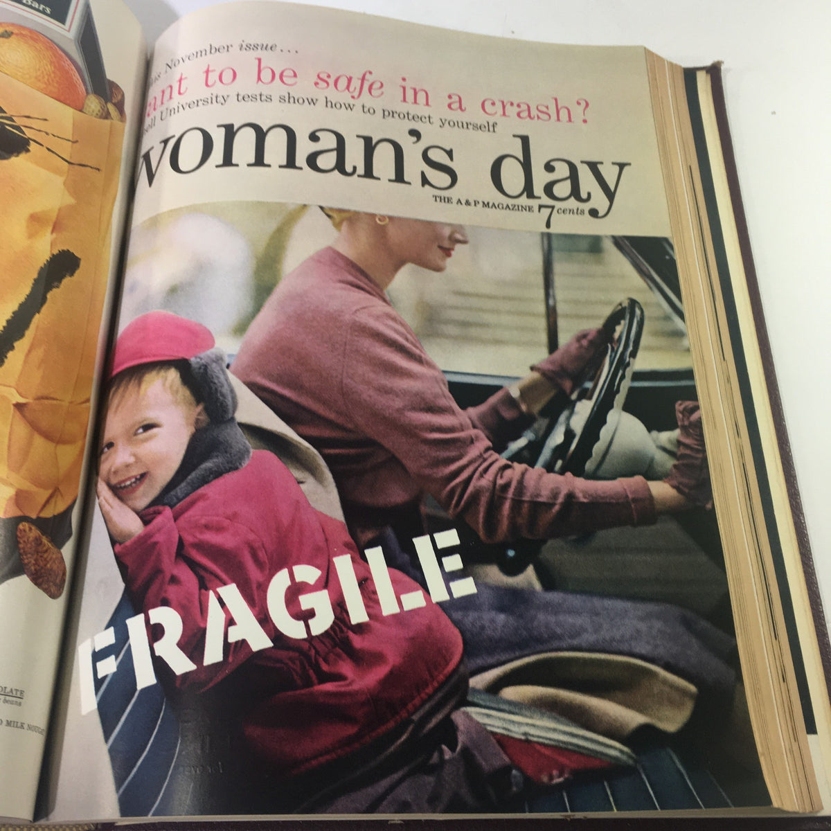 Cover of 1954 Woman's Day Magazine featuring a woman driving a car with a boy in a winter coat smiling, illustrating 1950s American family life.