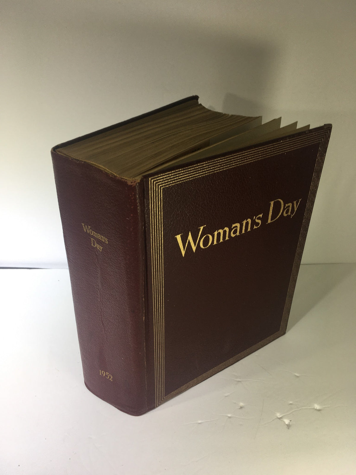 1952 Woman's Day Magazine Complete Year Round In One Book Compilation showcasing the exterior of the vintage compilation with gold lettering.