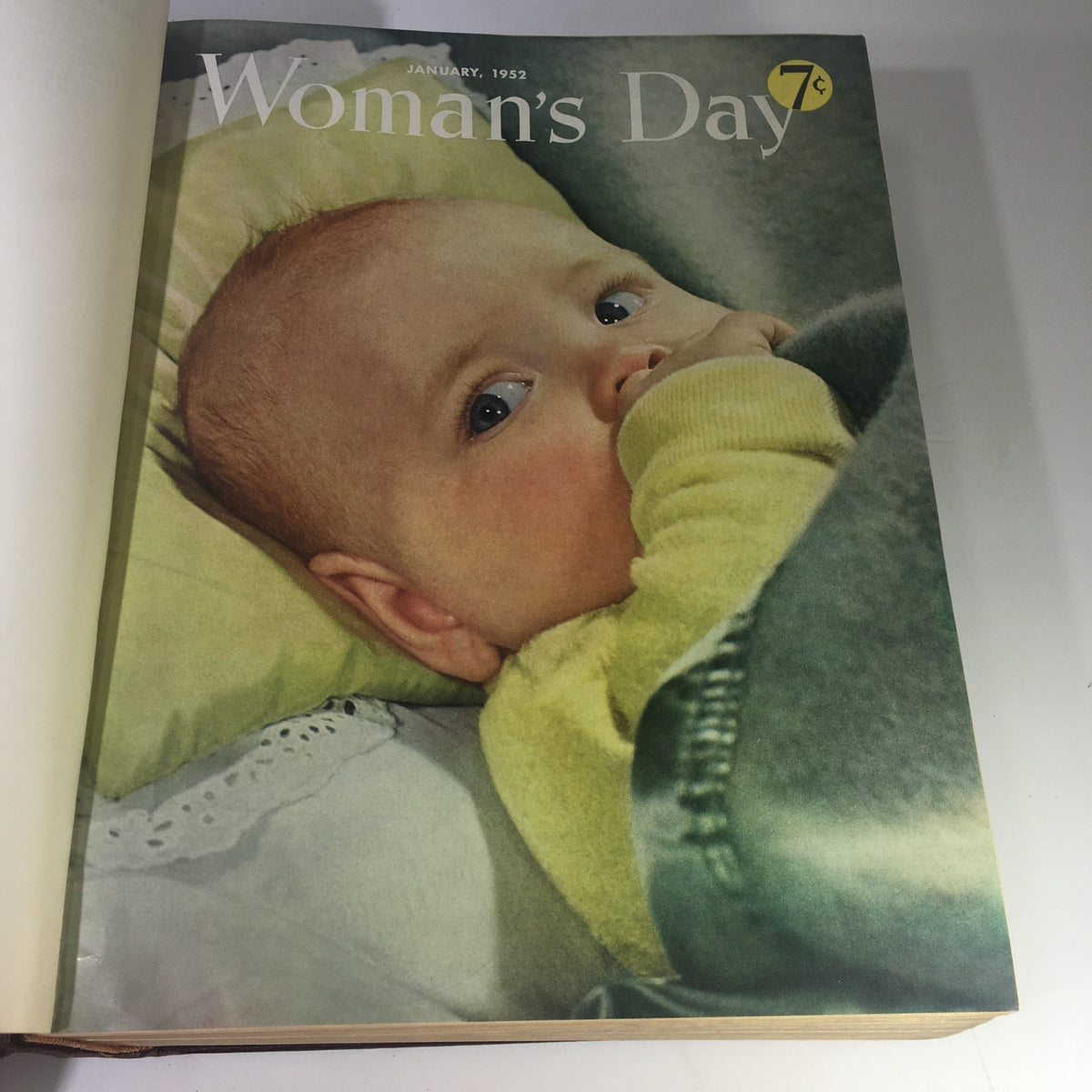 Cover page of January 1952 issue from the 1952 Woman's Day Magazine Complete Year Round In One Book Compilation, featuring a baby with blue eyes and a nostalgic design.