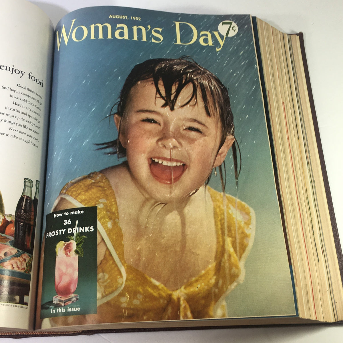 Cover of the August 1952 Woman's Day Magazine featuring a joyful girl in a yellow swimsuit, showcasing summer fun and nostalgia.