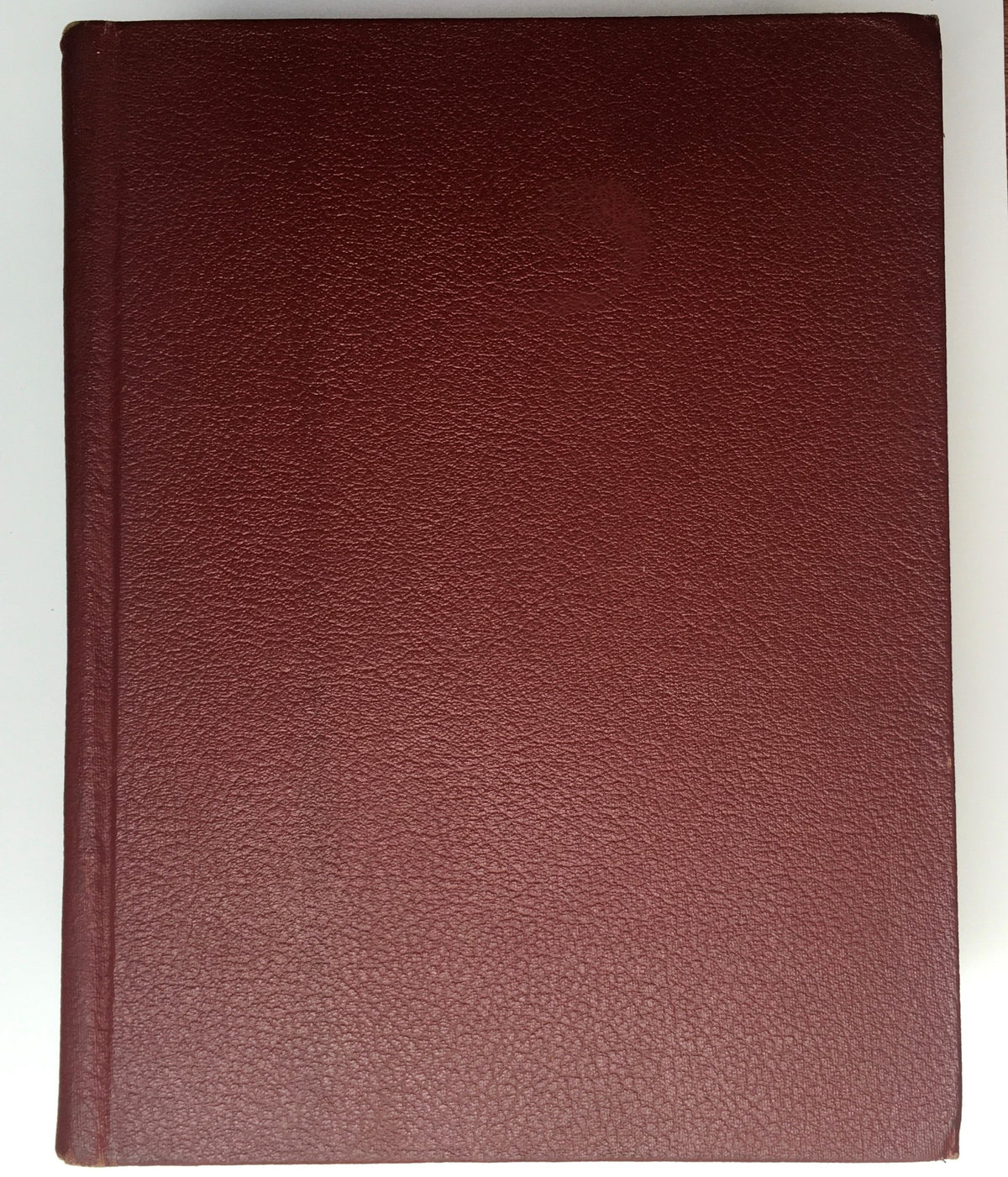 The plain maroon cover of the 1952 Woman's Day Magazine Complete Year Round In One Book Compilation, highlighting the vintage aesthetic.