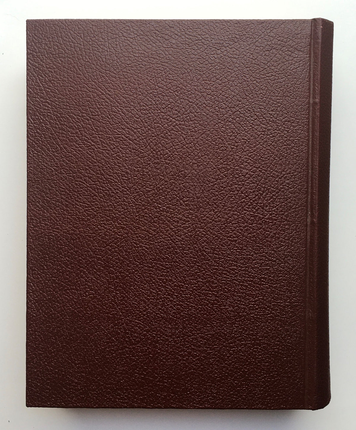 The spine of the 1951 Woman's Day Magazine Complete Year Round In One Book Compilation, showcasing its vintage brown leather-like cover.