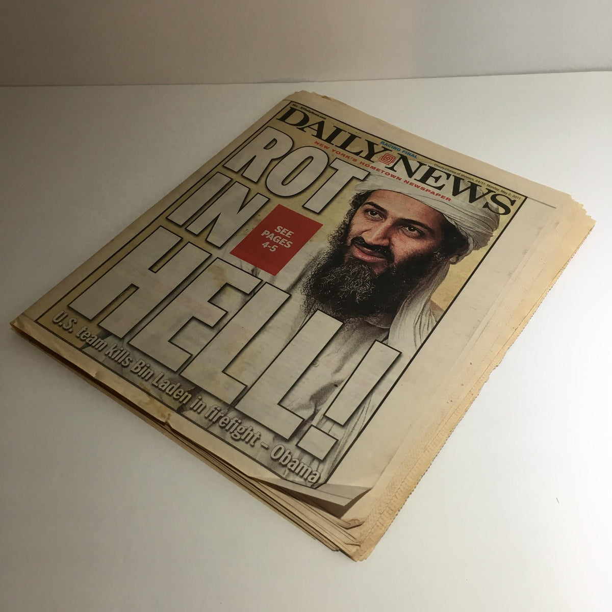 Cover of NY Daily News from May 2, 2011, prominently displaying the headline 'ROT IN HELL!' with an image related to Osama Bin Laden, capturing a significant historical moment.