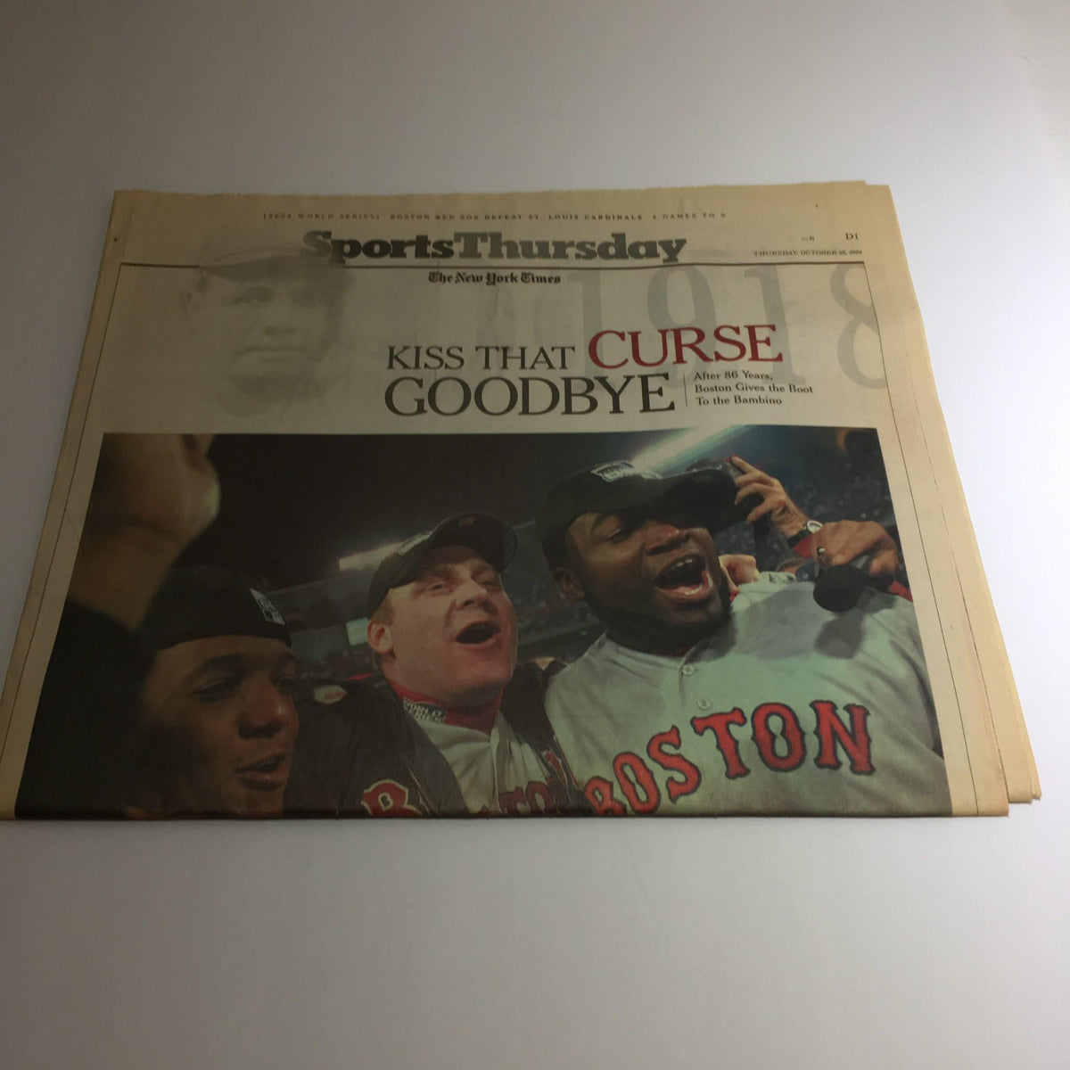 The New York Times headline "Kiss That Curse Goodbye" with celebratory fans from the Boston Red Sox celebrating on the cover of the October 28, 2004 issue.