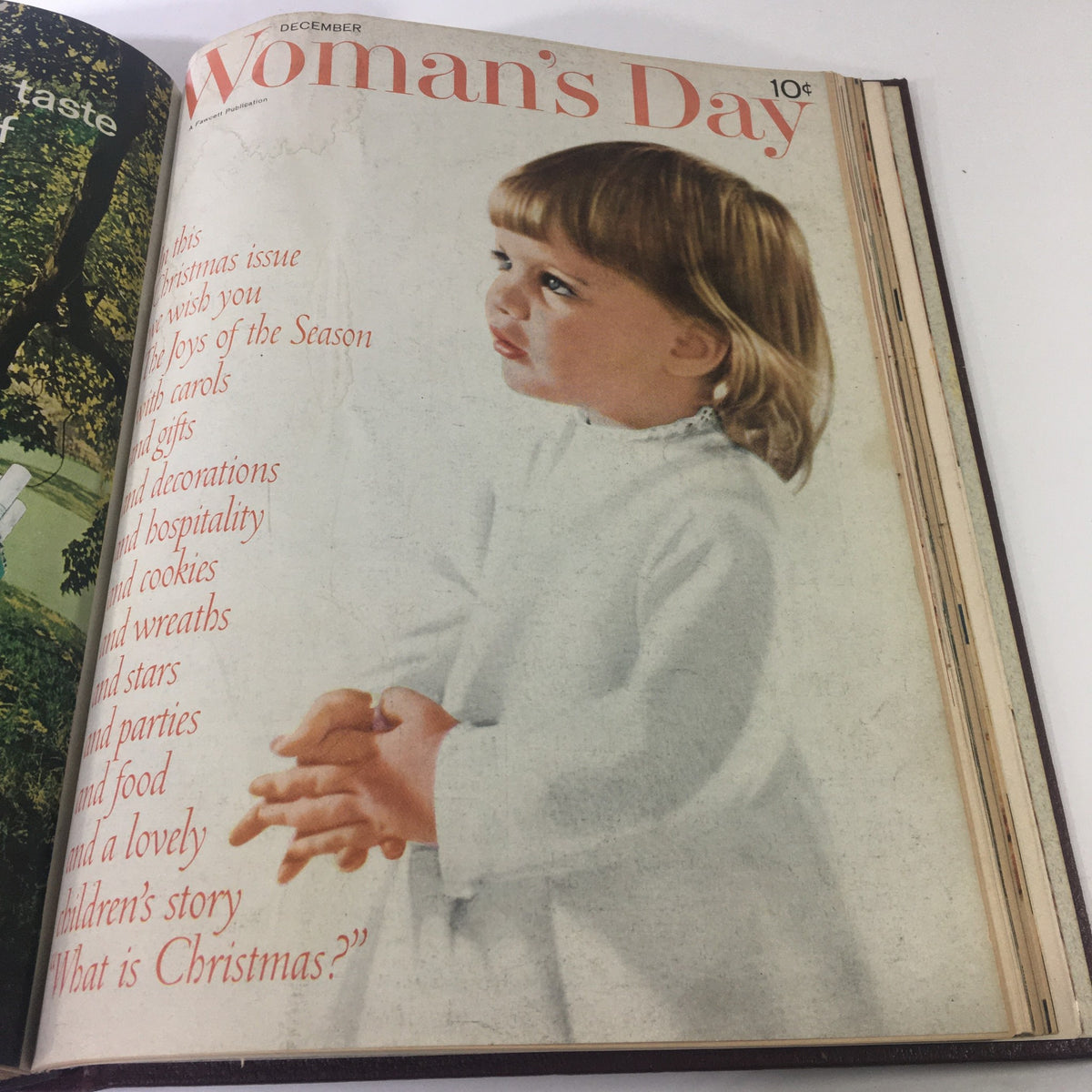 Cover of the December 1960 Woman's Day Magazine showing a young girl in a white dress, illustrating the holiday spirit and themes of Christmas celebrations.