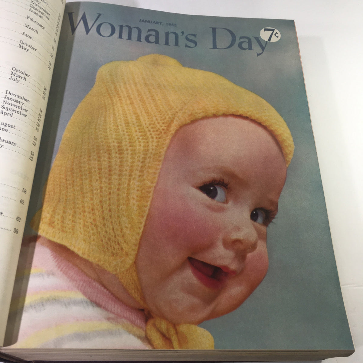 January 1953 issue of Woman's Day magazine showcasing a charming image of a smiling baby wearing a yellow knitted bonnet, embodying the nostalgic essence of 1950s magazine covers.