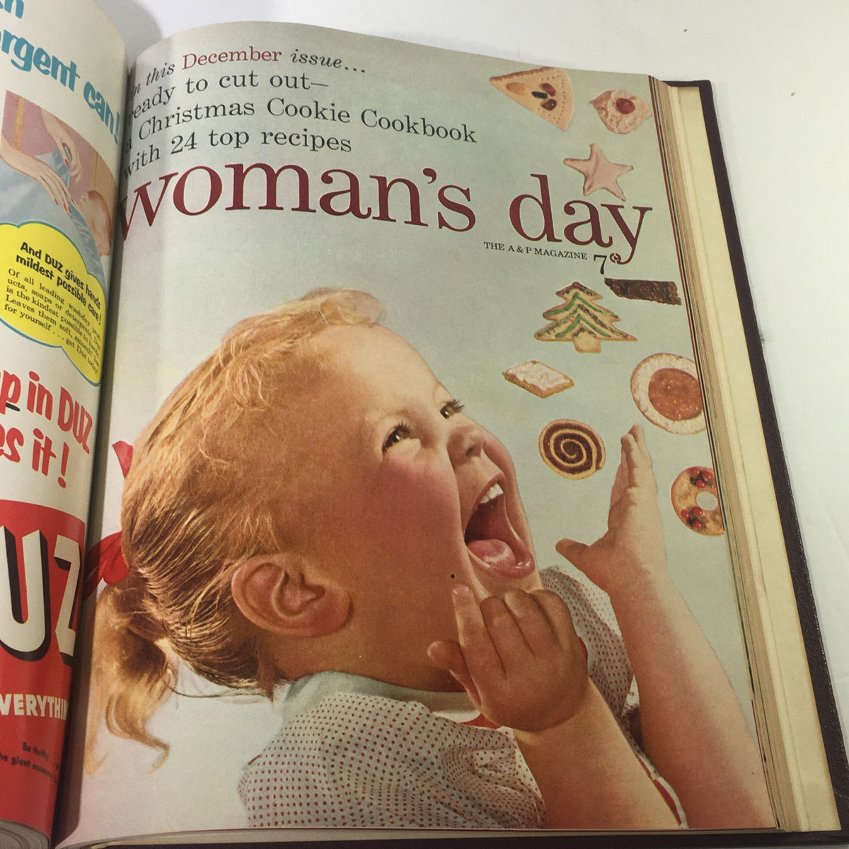 December 1953 Woman's Day Magazine featuring a joyful child surrounded by Christmas cookies, representing festive baking inspirations.