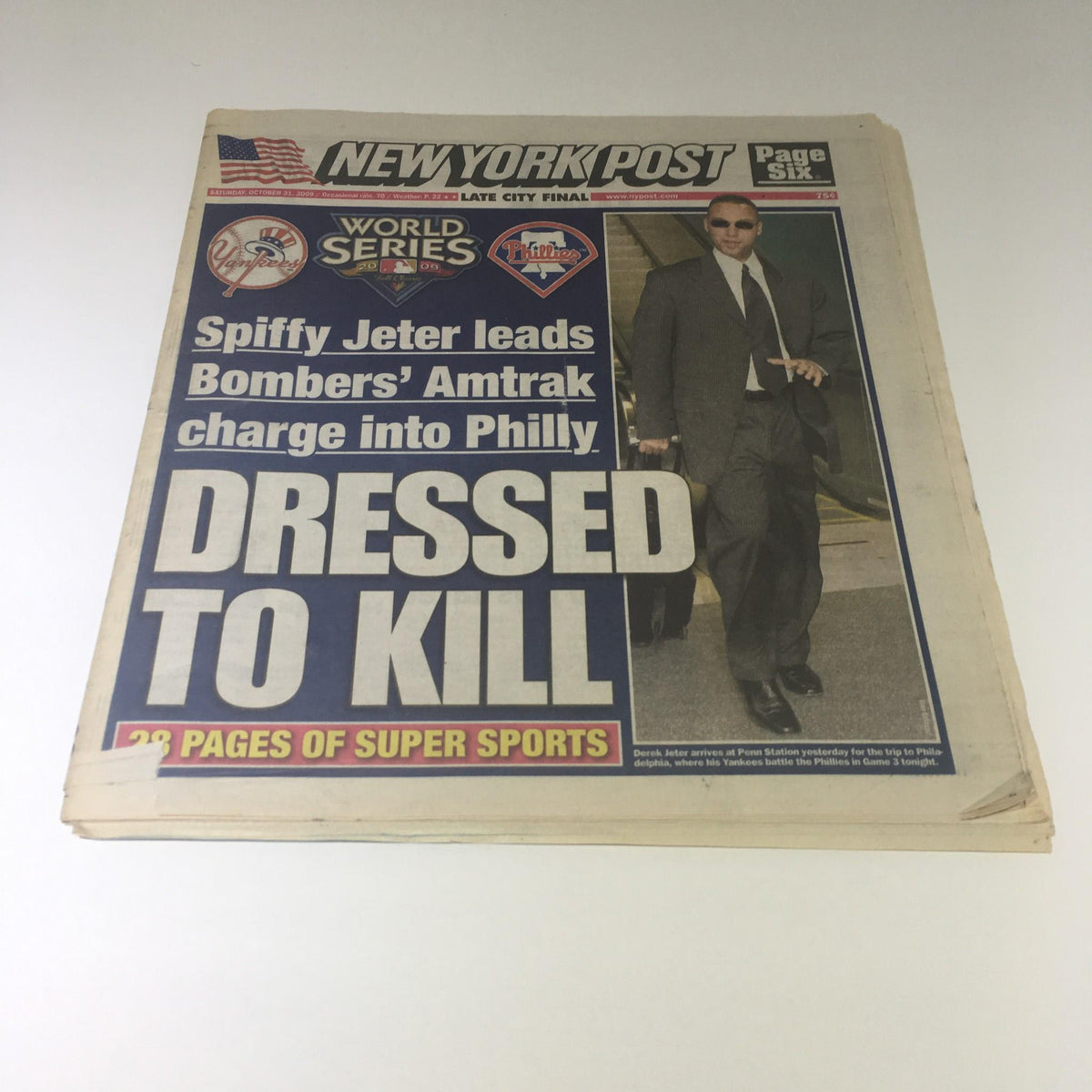 New York Post from October 31, 2009, featuring the headline 'Dressed To Kill' with a photo of a man in a suit walking confidently.