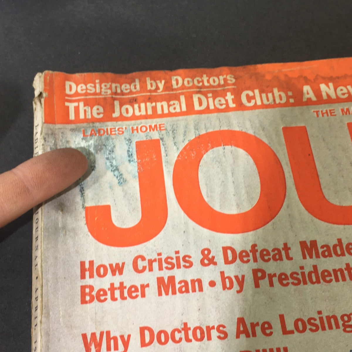 Close-up of the worn cover of VTG Journal Magazine April 1969 featuring signs of aging and wear.