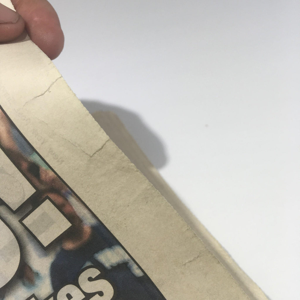 Image of the July 10, 2011, New York Post newspaper featuring a worn edge, emphasizing the historical moment of Derek Jeter's home run.