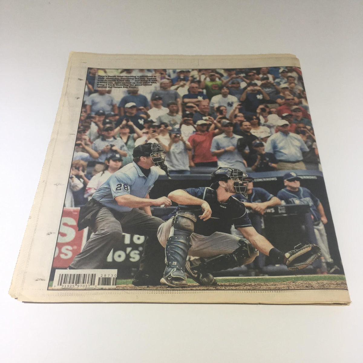Back view of the New York Post showcasing fans celebrating during the game where Derek Jeter made history with his 3000th hit.