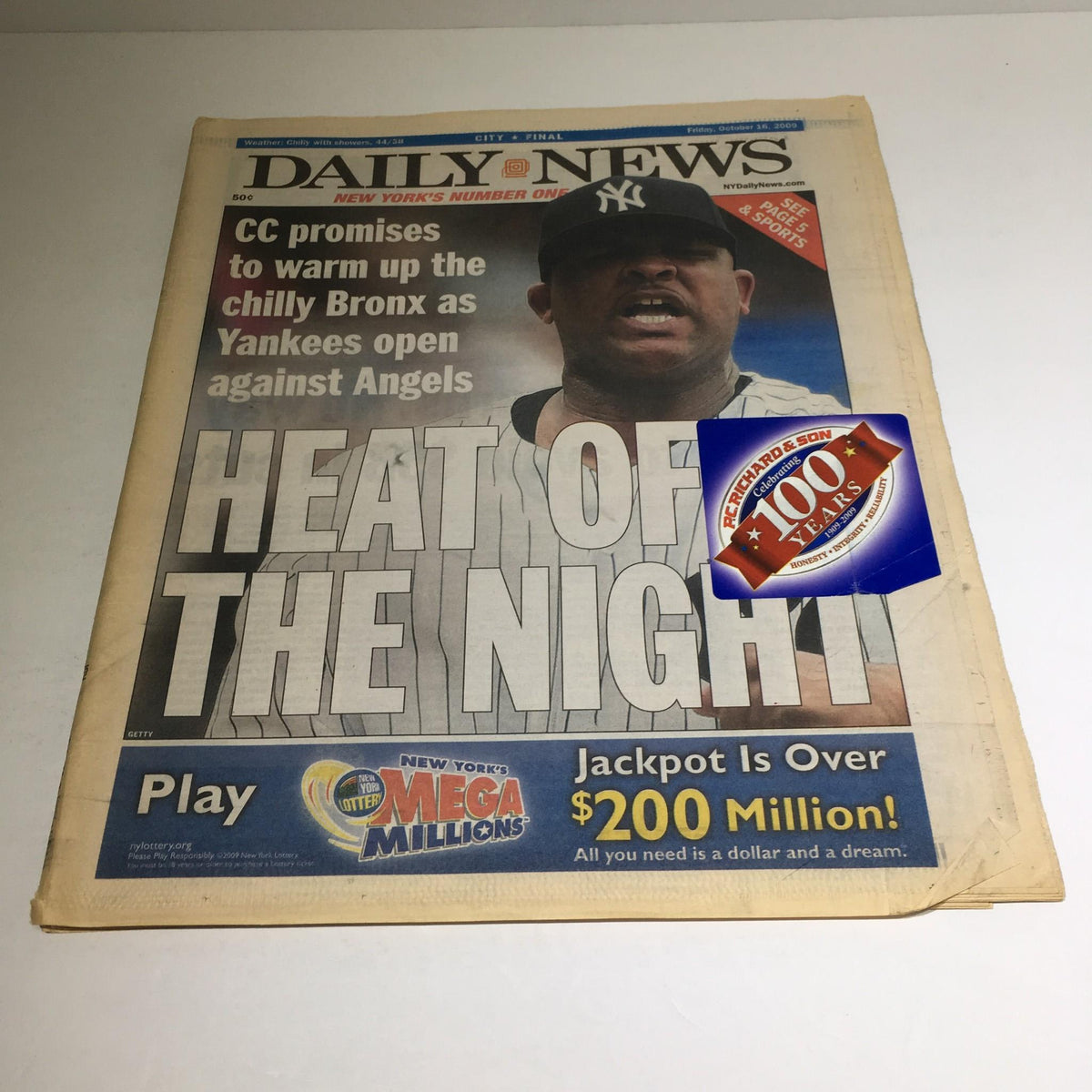 New York Daily News newspaper from October 16, 2009, featuring the headline 'HEAT OF THE NIGHT' with a large image of CC Sabathia, highlighting the announcement of the Yankees' game against the Angels and a promotion for the Mega Millions lottery.