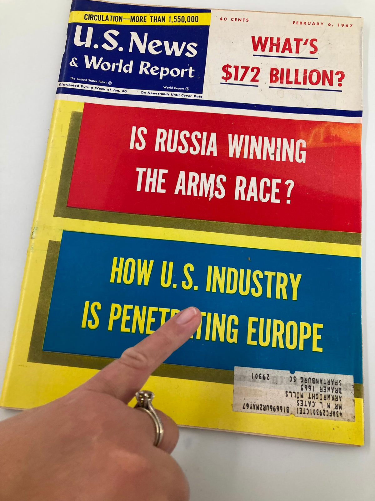 US News & World Report Magazine February 6, 1967 cover focusing on 'Is Russia Winning The Arms Race?' with a hand pointing to the section on U.S. industry in Europe.