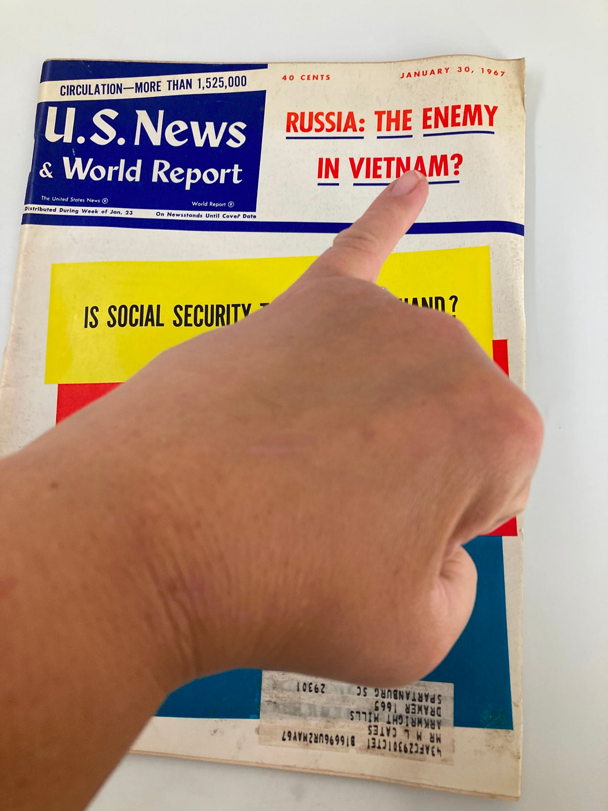 Close-up of the cover of US News & World Report Magazine January 30, 1967, highlighting the headline 'Russia: The Enemy in Vietnam?' with a hand pointing at it.