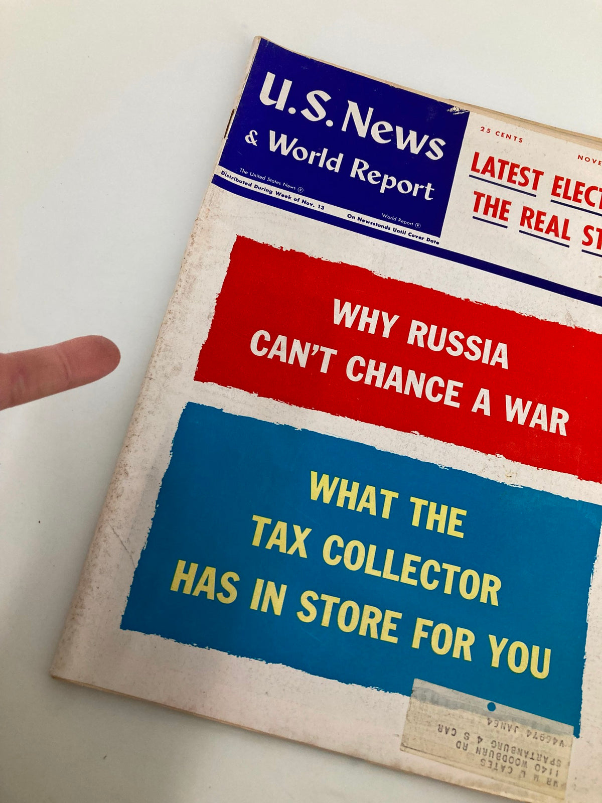 Close-up view of US News & World Report Magazine cover from November 20, 1961, highlighting the provocative title 'Why Russia Can't Chance a War' and additional text about taxes, showcasing historical context.