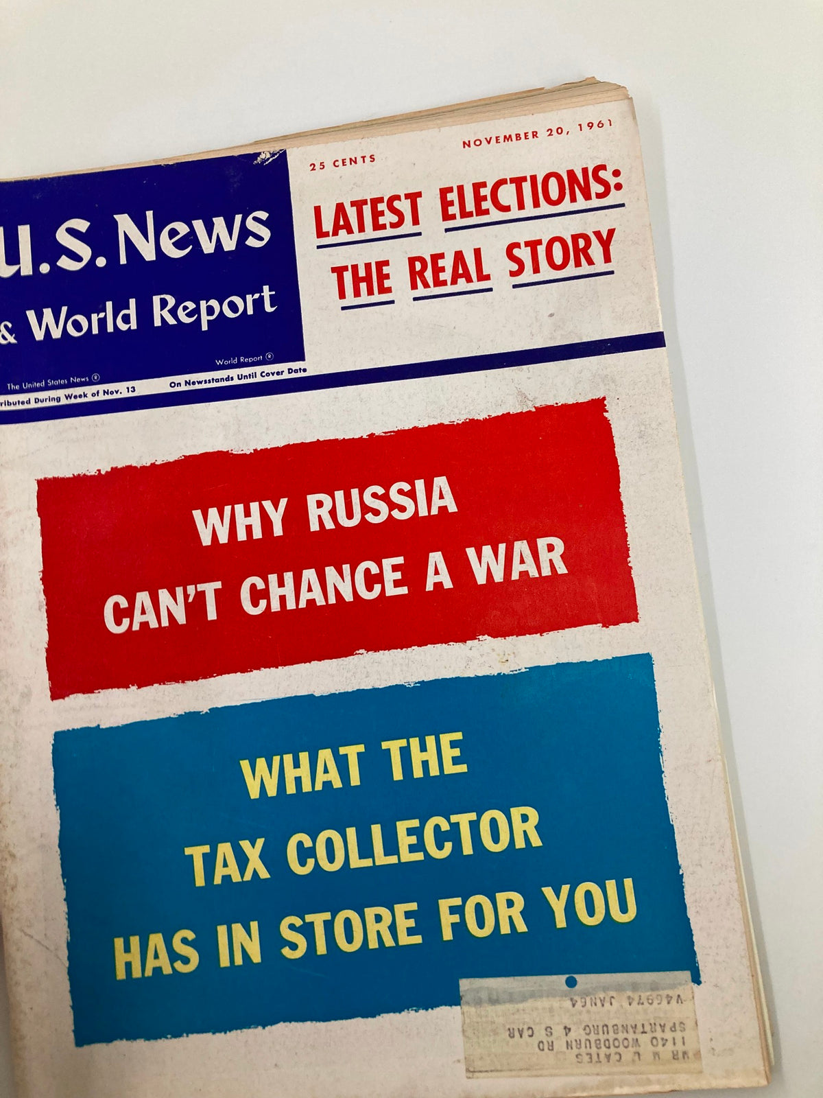 Another angle of the US News & World Report Magazine, November 20, 1961, displaying key headlines including 'Why Russia Can't Chance a War', serving as a snapshot of political themes from the Cold War era.
