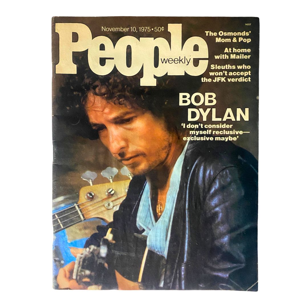 Cover of the VTG People Weekly Magazine from November 10, 1975, featuring an iconic photograph of musician Bob Dylan, showcasing his profile while holding a guitar, with the headline quote, 'I don't consider myself reclusive — exclusive maybe'. This vintage magazine is a collectible item for fans of Bob Dylan and 1970s pop culture.
