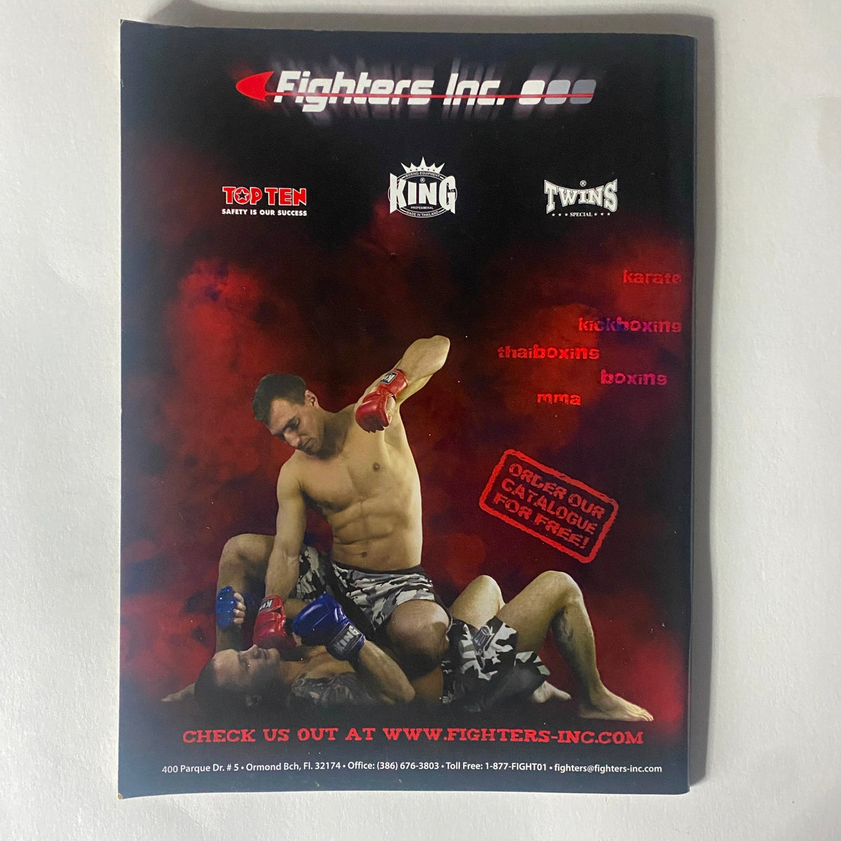 Back cover of MMA Sports Magazine Issue 14, displaying an advertisement for Fighters Inc with a dynamic image of fighters in action.