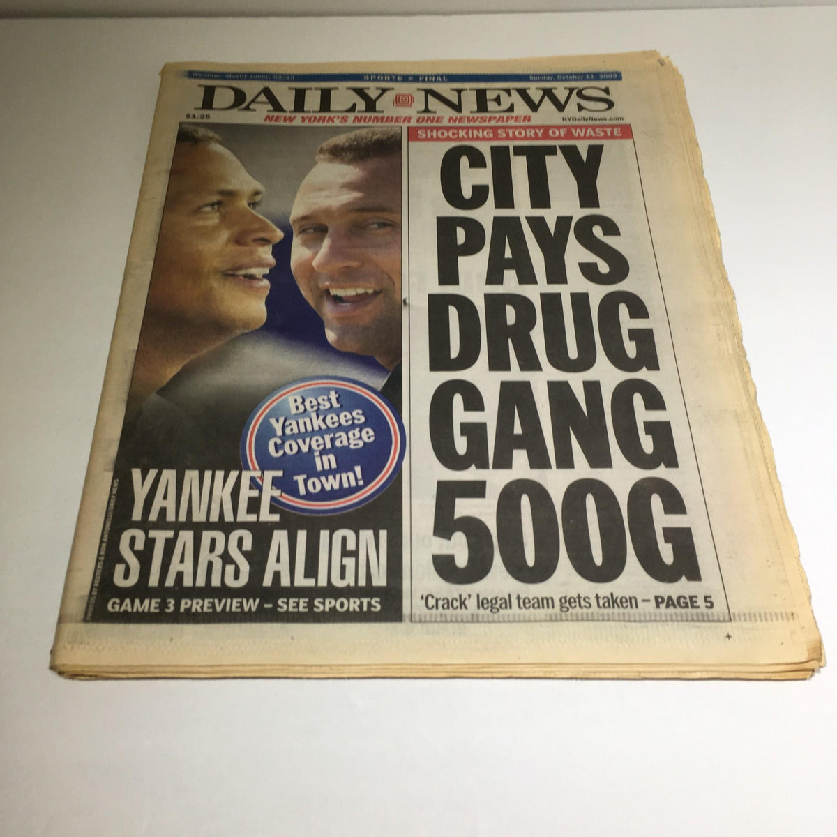 Front page of NY Daily News dated 10/11/2009 featuring the headline 'City Pays Drug Gang 500G' with a subheading 'Yankee Stars Align' and a preview of Game 3.