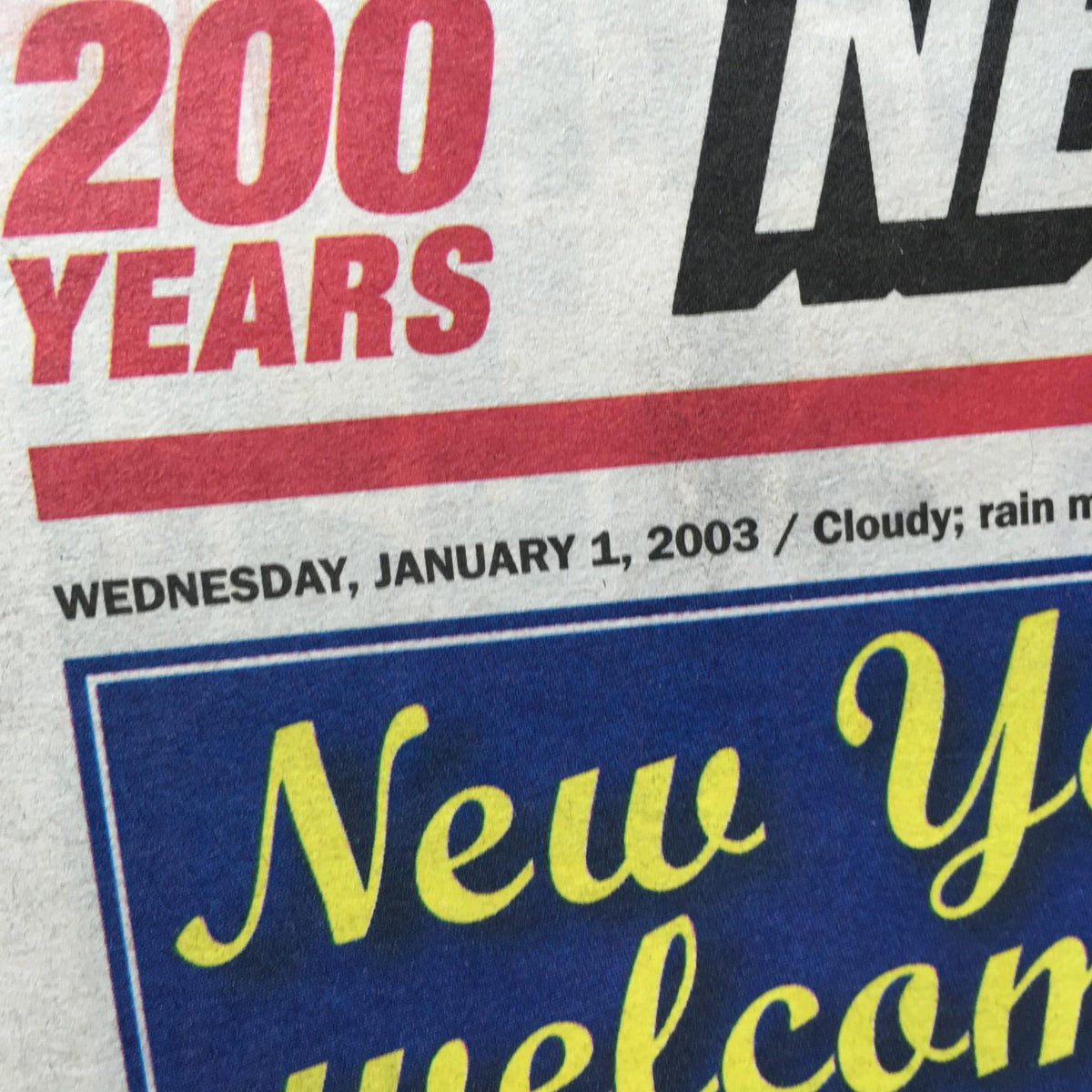 Top section of the New York Post newspaper dated January 1, 2003, highlighting a weather report for the day and the headline 'New York welcomes 200 years.'