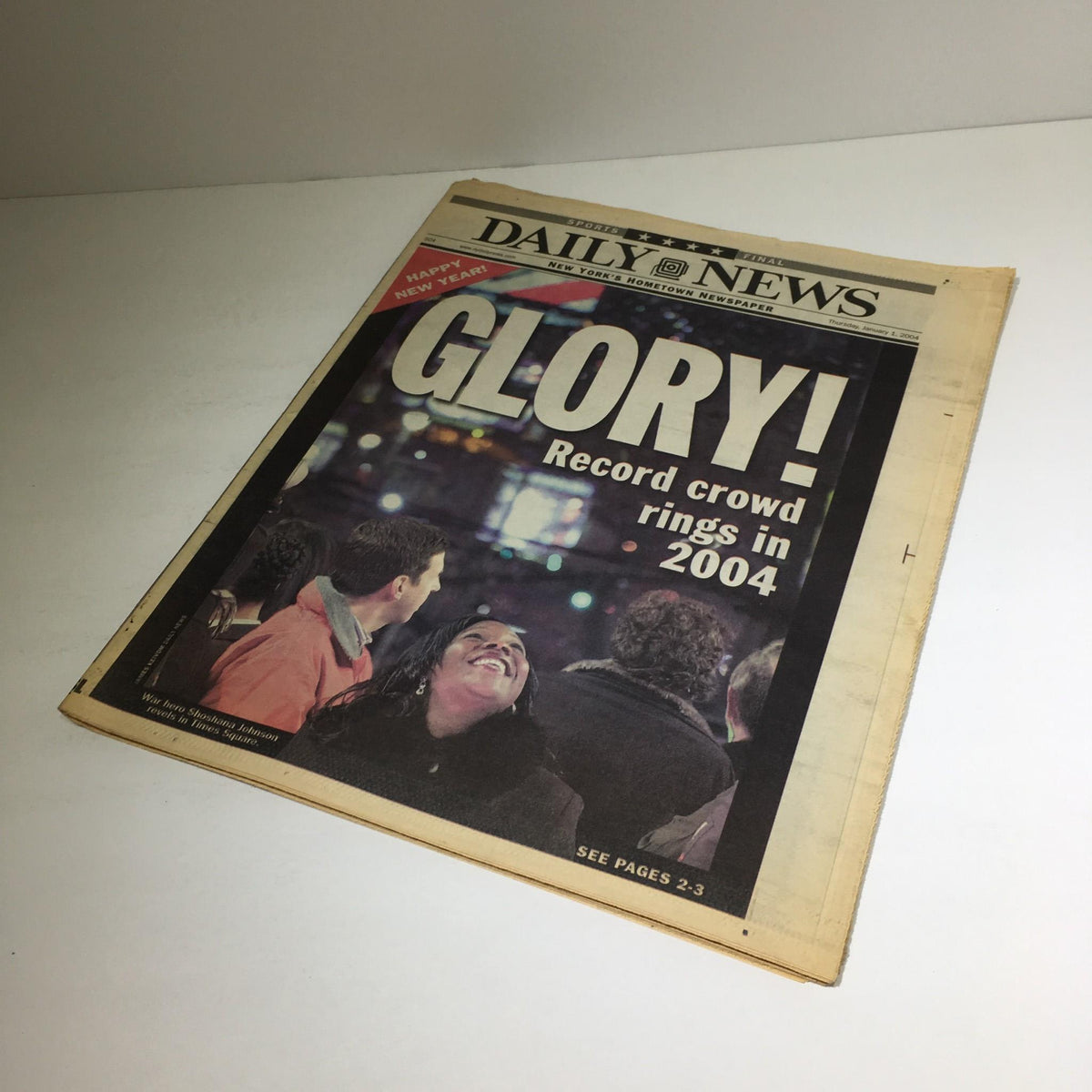 Another view of the New York Daily News front page reading 'Glory! Record crowd rings in 2004', emphasizing the festive atmosphere in Times Square during New Year's celebrations.