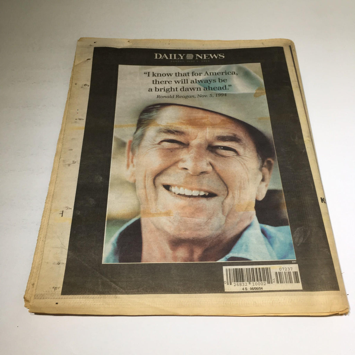 Front cover of the New York Daily News: 06/6/04, featuring a smiling portrait of Ronald Reagan with a quote, reflecting on his enduring legacy.