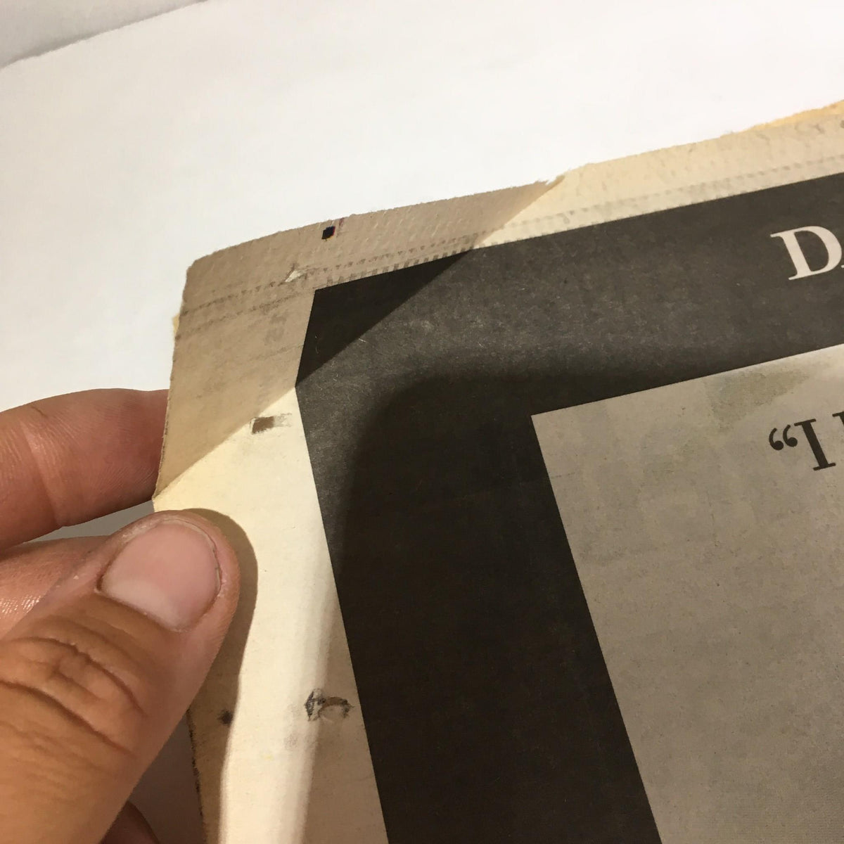 Close-up of the torn edge of the New York Daily News: 06/6/04, illustrating the newspaper's condition as a vintage collectible.