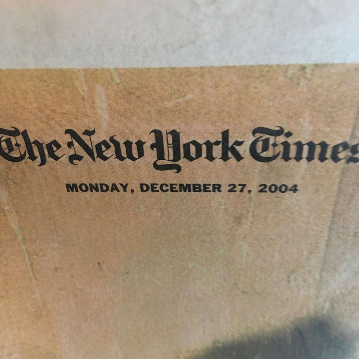 The New York Times: Dec 27 2004, 2004 The Year in Pictures, displaying the newspaper's title prominently, marking a significant date with a vintage design.
