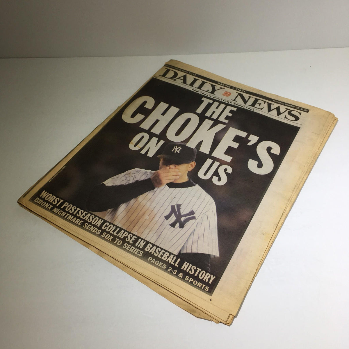 New York Daily News cover from October 21, 2004 read 'The Choke's on US', highlighting a pivotal moment in postseason baseball history.