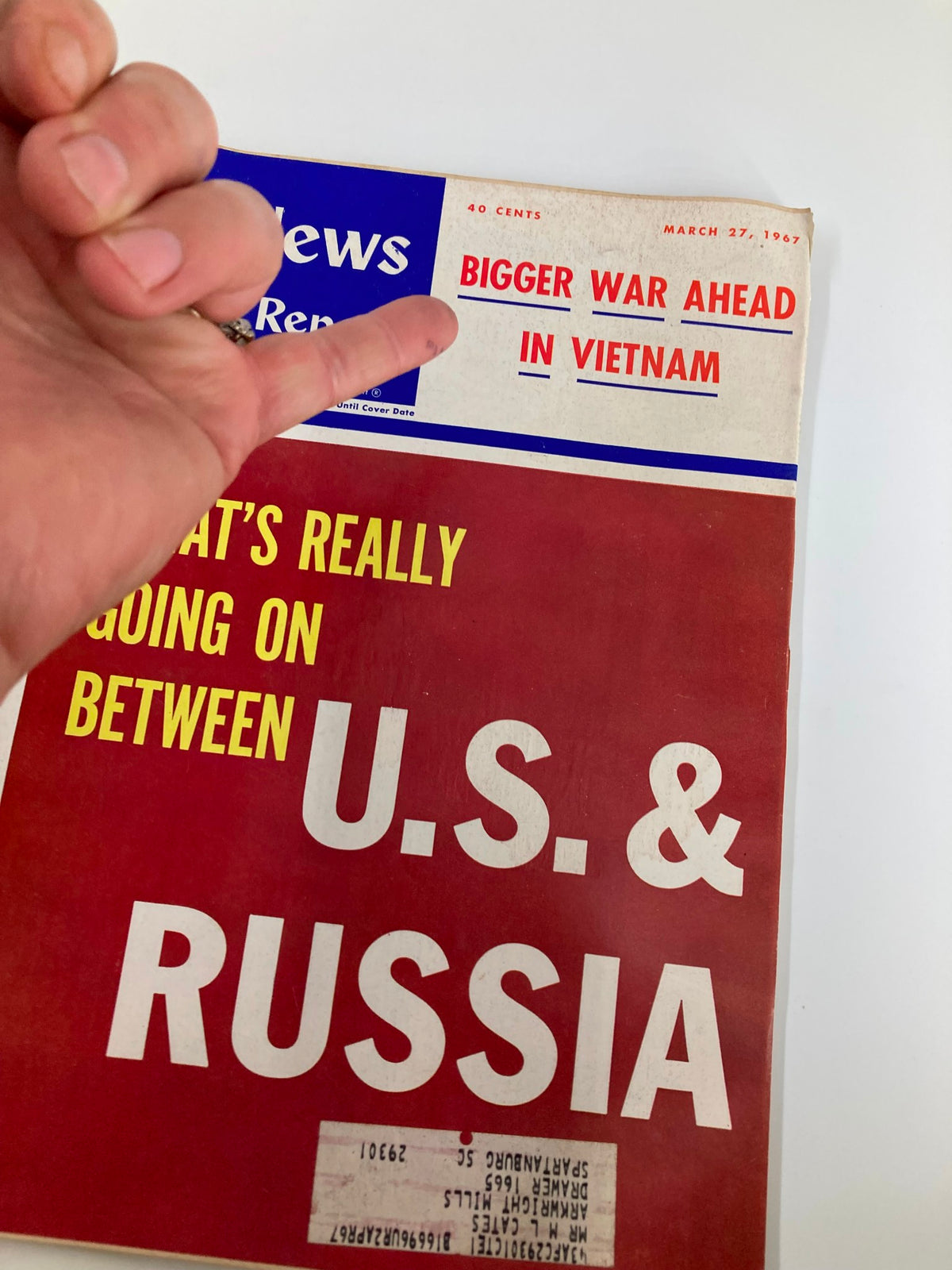 Close-up of the cover of US News & World Report Magazine March 27, 1967 highlighting the headline 'Bigger War Ahead in Vietnam' with a hand pointing at it.