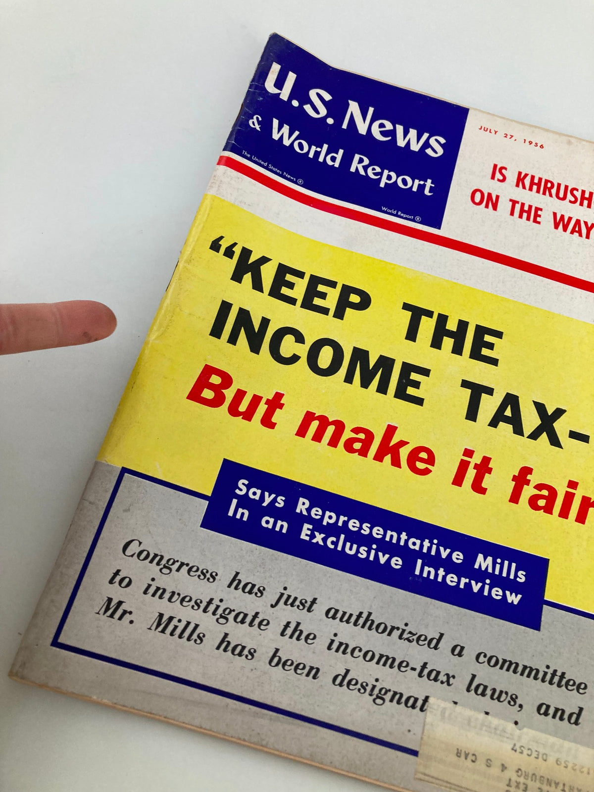 Close-up view of the cover of US News & World Report Magazine, July 27, 1956, highlighting the headline 'Is Khrushchev On The Way Out?' and a focus on income tax discussion.