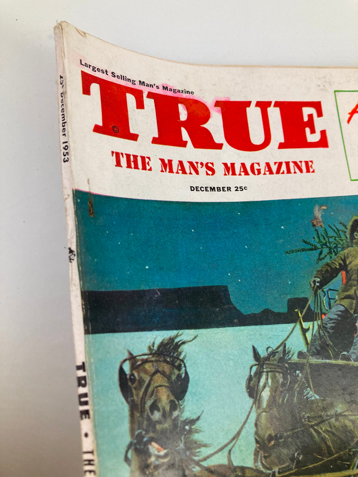 Close-up view of the cover of TRUE The Man's Magazine December 1953, showcasing the magazine title and festive graphics along with the date.