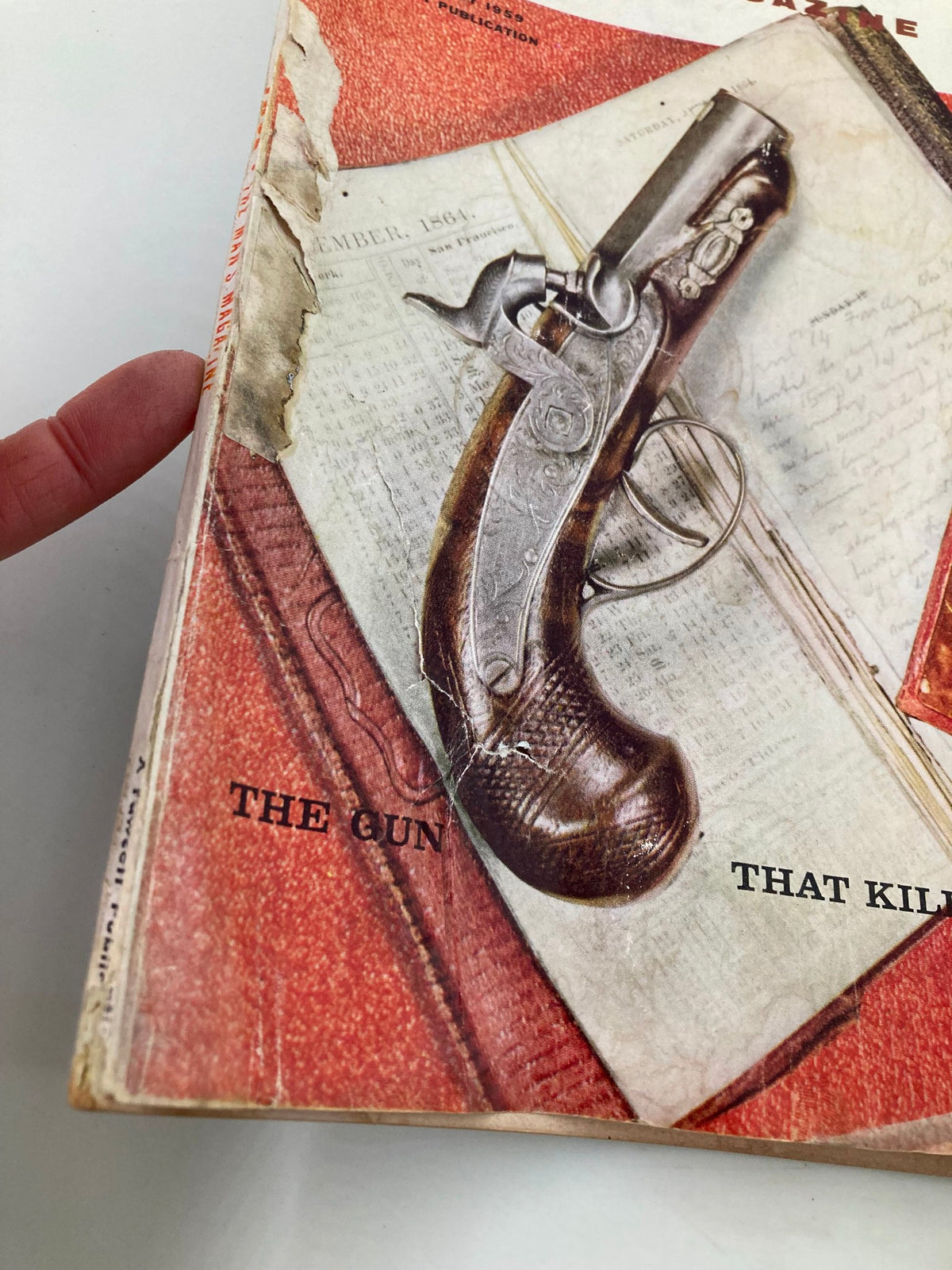 Close-up view of the cover of TRUE The Man's Magazine February 1959 highlighting the title 'The Gun That Killed Lincoln' with detailed imagery of a vintage pistol and worn edges of the magazine.