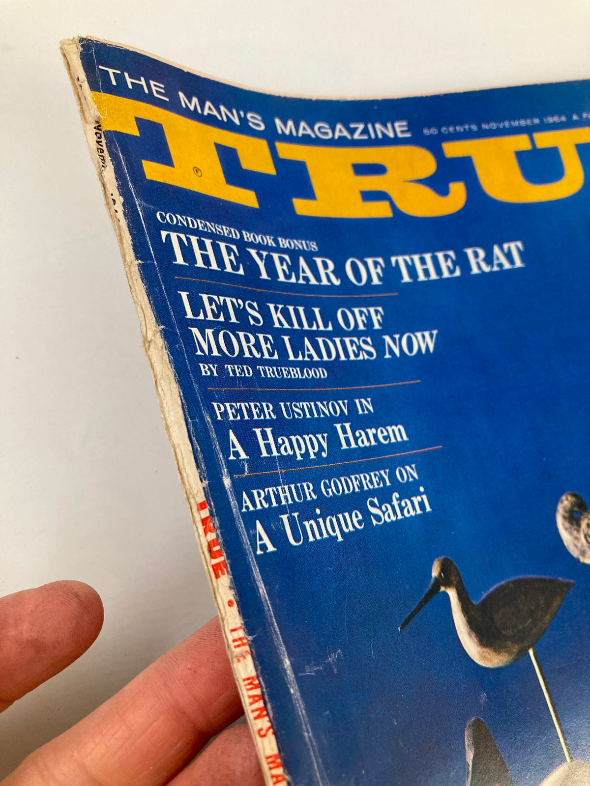 Side view of TRUE The Man's Magazine November 1964 showing the magazine's title and details about articles featured inside, reflective of mid-20th century design.
