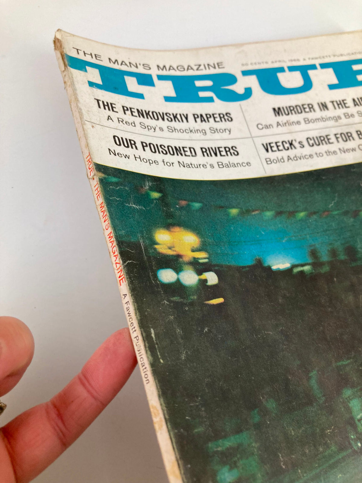 Close-up shot of the spine and cover detail of TRUE The Man's Magazine, April 1966, highlighting the title and various featured articles.